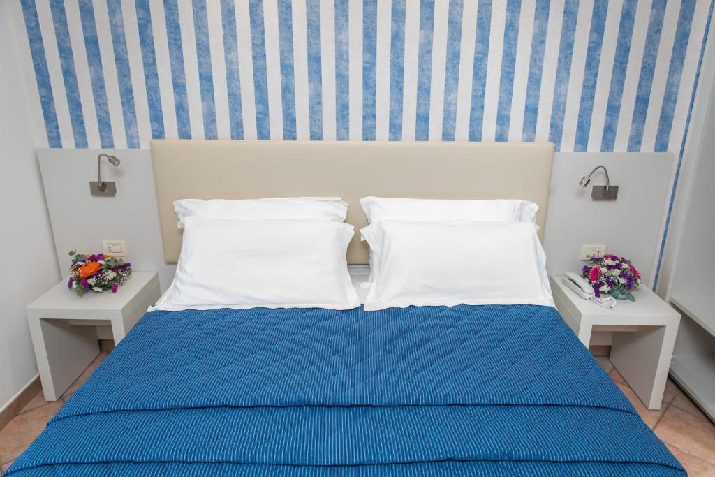 Postel nebo postele na pokoji v ubytování Hotel Martino