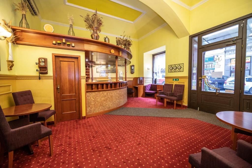a bar in a restaurant with tables and chairs at Old Prague Hotel in Prague