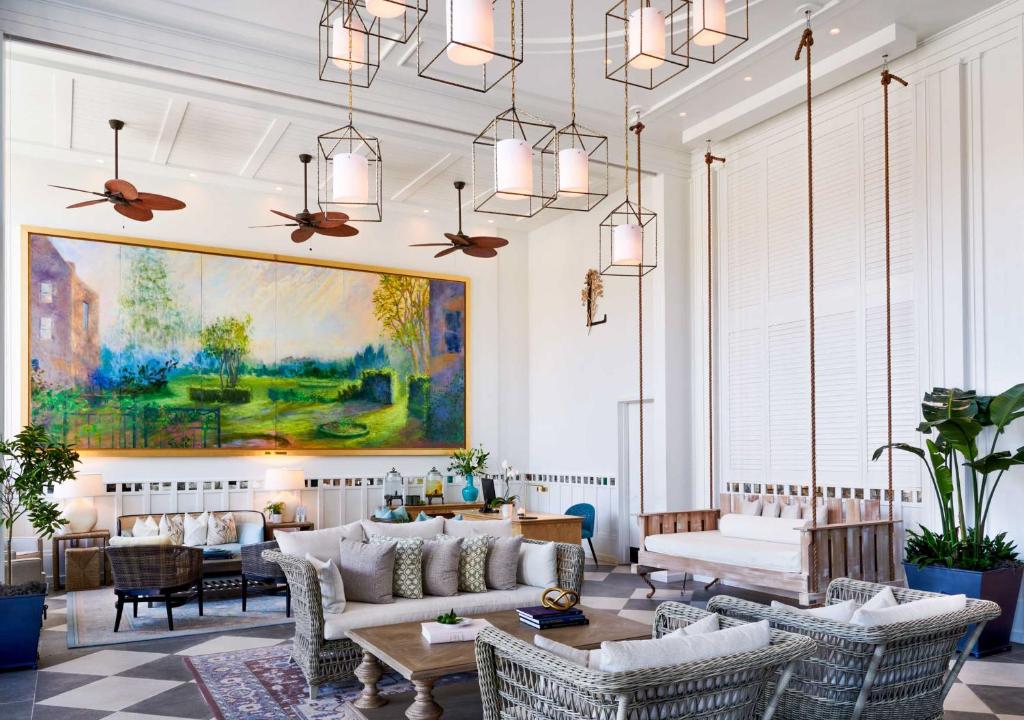 a living room with furniture and a painting on the wall at The Loutrel in Charleston