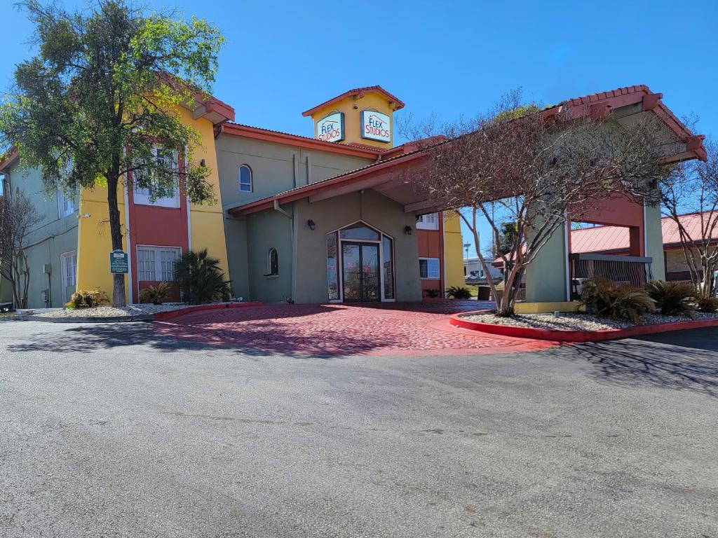 a building with a clock tower on top of it at Flex Studios in San Antonio