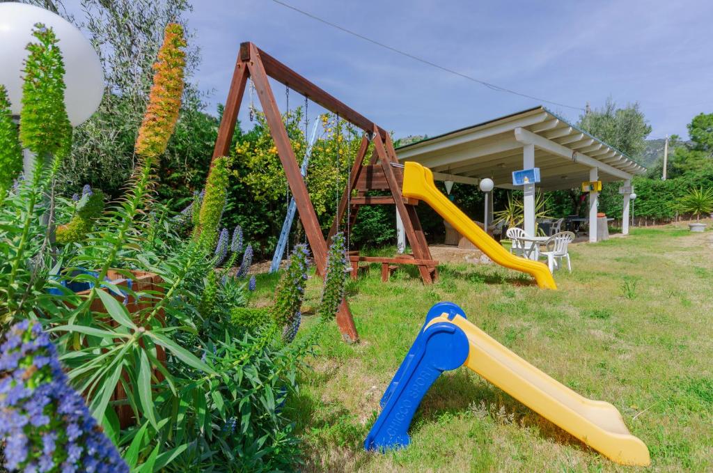 a playground with two slides and a swing at B&B Tor Di Lupo in Mattinata