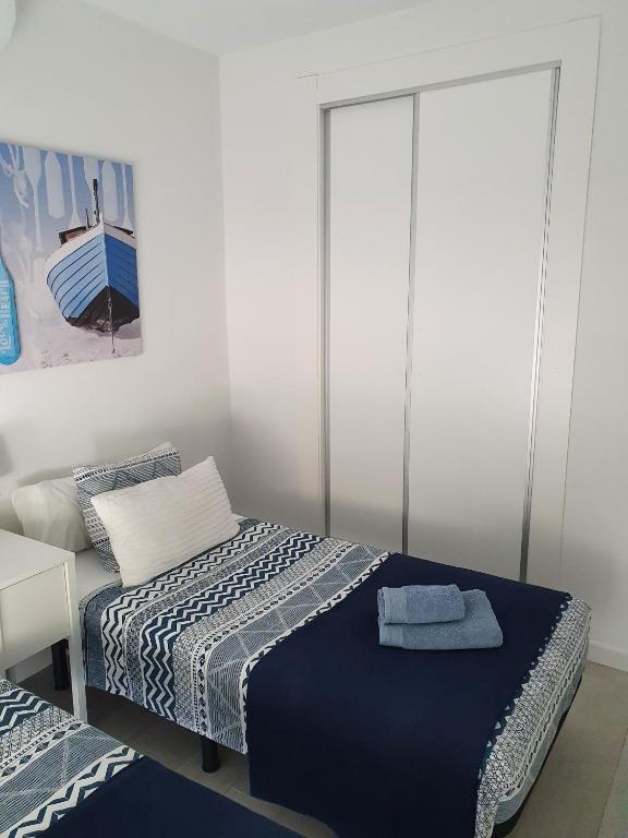 Łóżko lub łóżka w pokoju w obiekcie Paraiso
