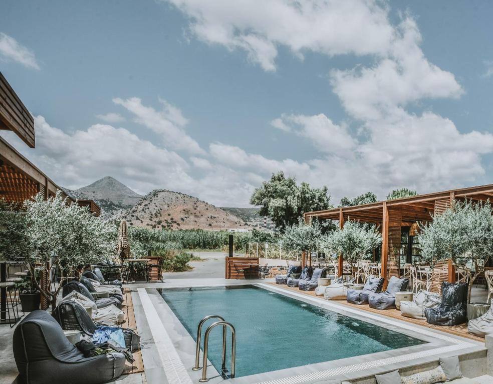 uma piscina com espreguiçadeiras e um resort em Ikaros Suites em Amoudara Herakliou