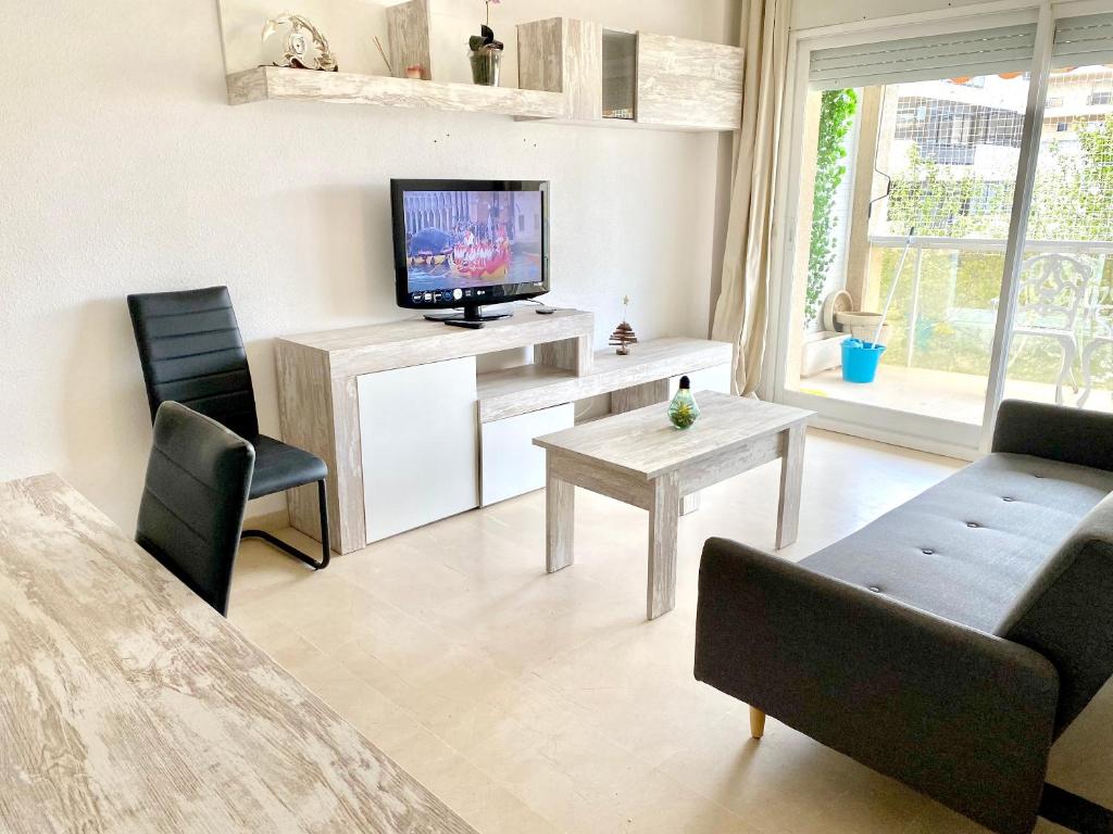 A television and/or entertainment centre at Modern Apartment in Salou - 50 m² + Pool