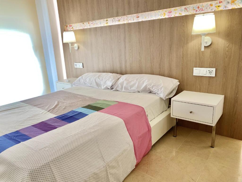 A bed or beds in a room at Modern Apartment in Salou - 50 m² + Pool
