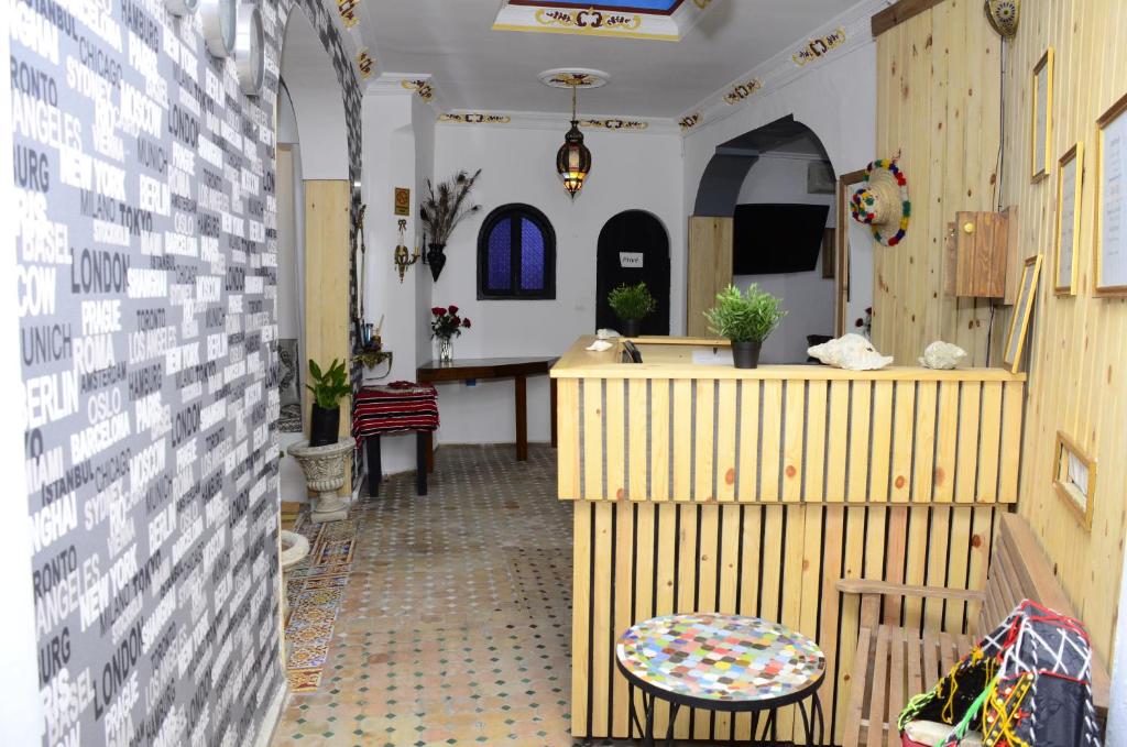 a hallway of a church with a table and chairs at Dar Rif Kebdani in Tangier