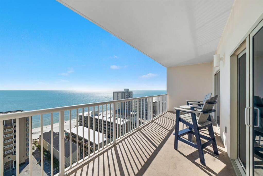 a balcony with chairs and a view of the ocean at Crystal Tower 1408 - Lazy River, Beachfront pool, Amazing Views, New Upgrades!! in Gulf Shores