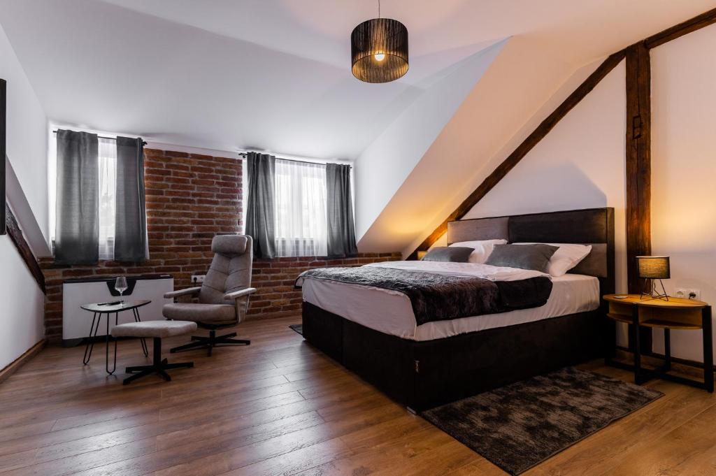 a bedroom with a bed and a desk and a chair at DreamHouse7 rooms in Zagreb