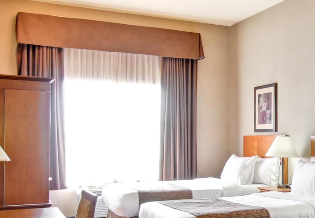 Een bed of bedden in een kamer bij Canalta Brooks