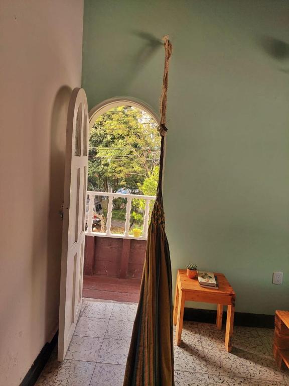 an open door with a dress hanging in a room at Tatami Hostel in Bucaramanga