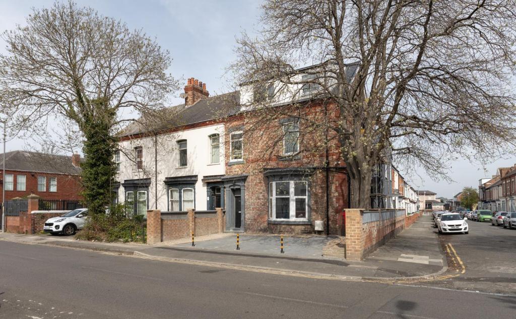 an old brick building on the corner of a street at Stockton town centre studio apartments free parking and Wi-Fi in Stockton-on-Tees