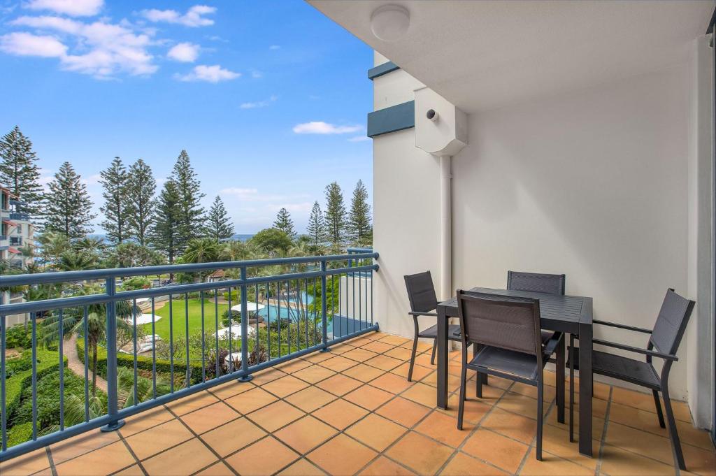 a balcony with a table and chairs on a balcony at Calypso Plaza Resort Unit 429 in Gold Coast