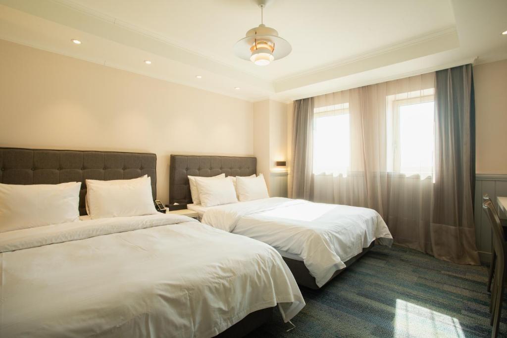 Postel nebo postele na pokoji v ubytování Winners Hotel