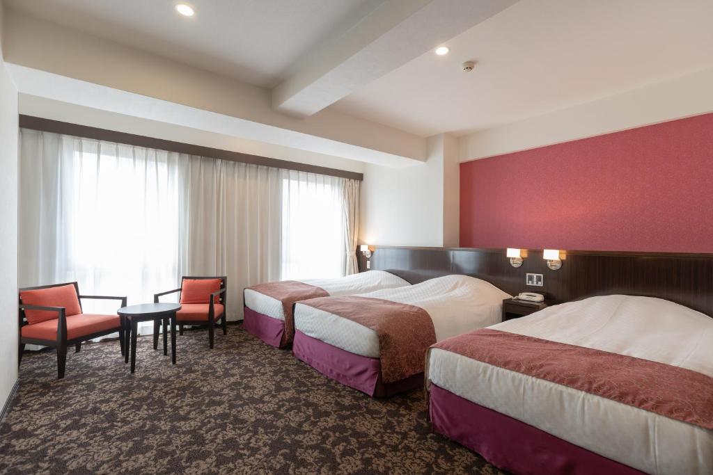 Postel nebo postele na pokoji v ubytování Libre Garden Hotel