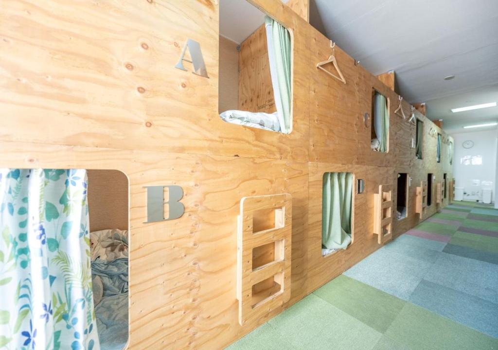 a wall of a room with a climbing wall at HOSTEL PAQ tokushima in Tokushima