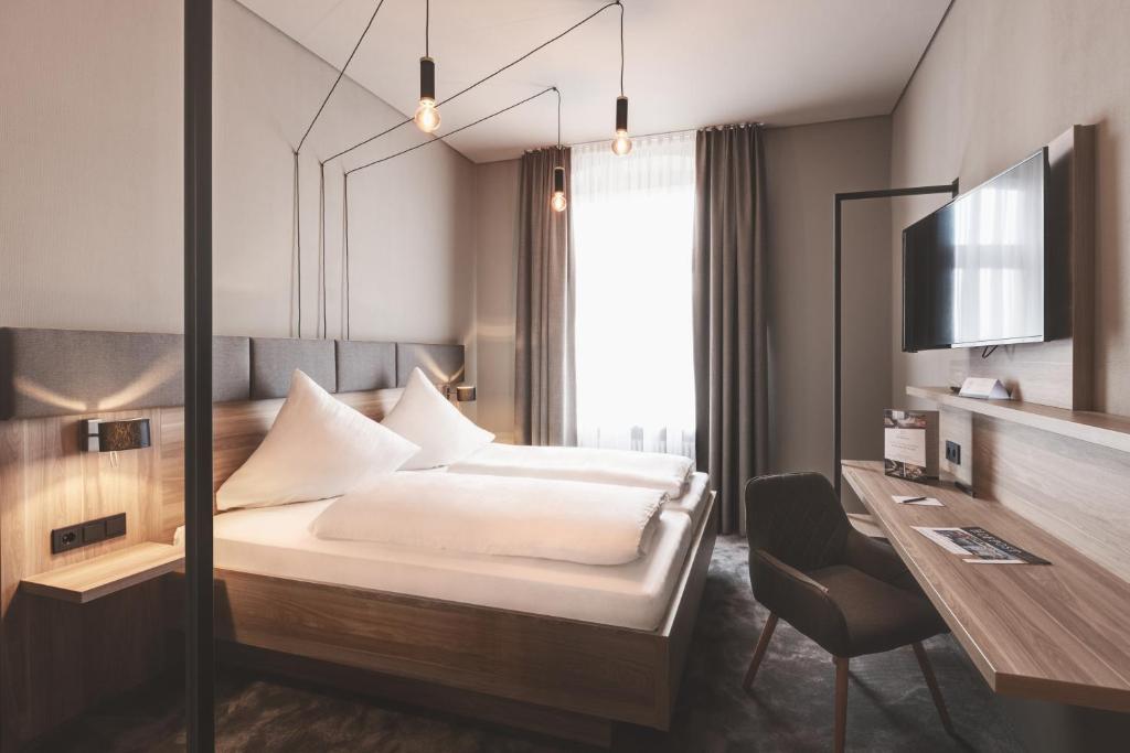 Postel nebo postele na pokoji v ubytování Hotel Das Bischof