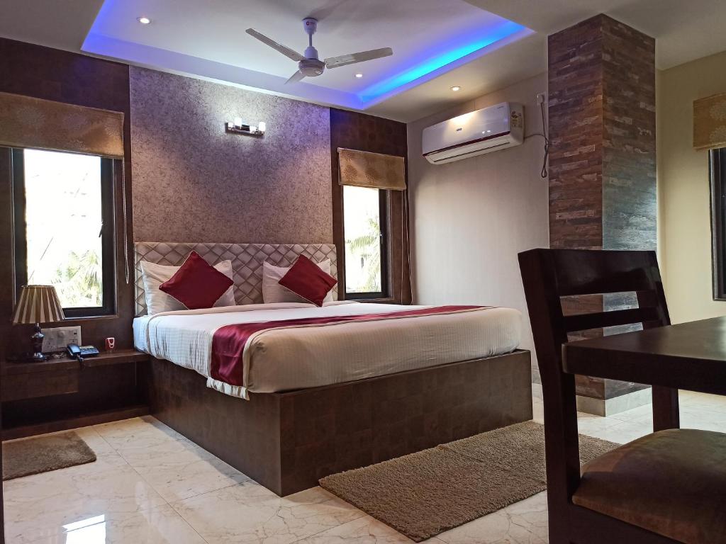 een slaapkamer met een groot bed met een blauw licht bij Hotel A P Home's - A Boutique Hotel in Guwahati
