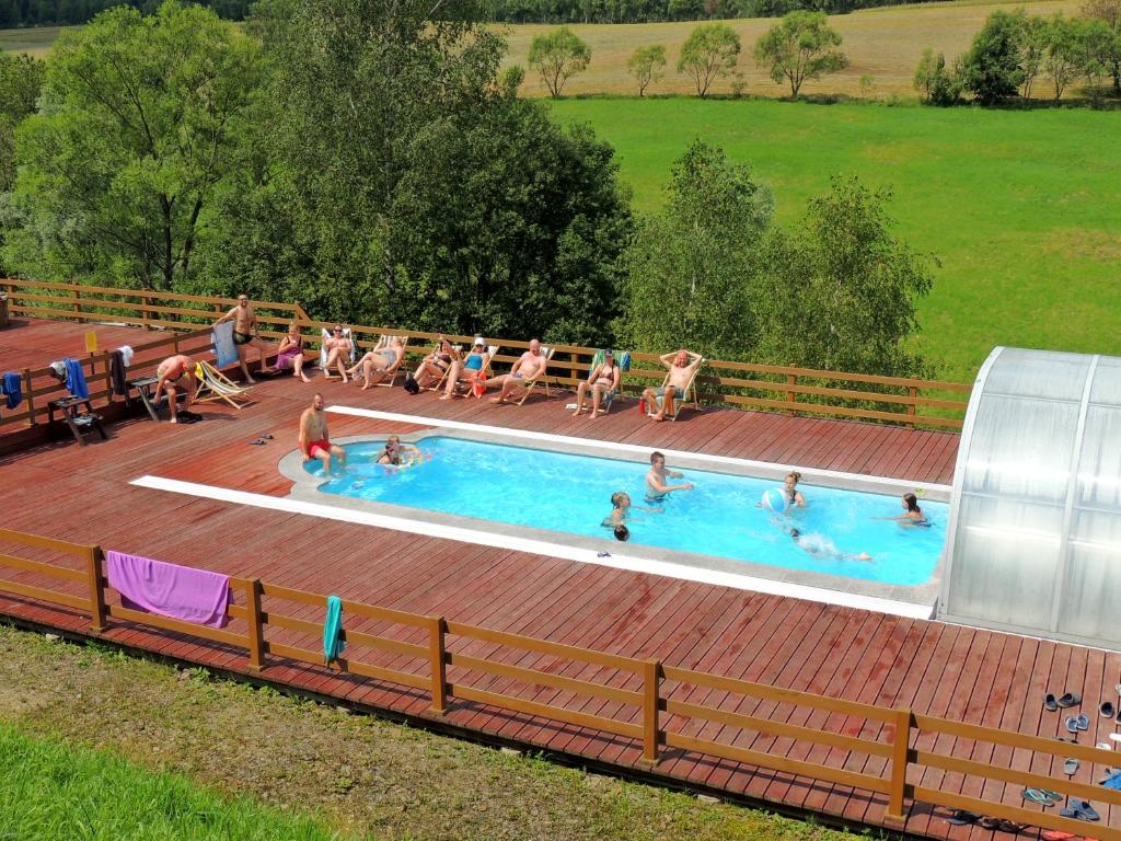 a group of people in a swimming pool at Edwardówka 601-130-636 - lipiec - sierpień - basen w cenie wynajmu domku in Polańczyk