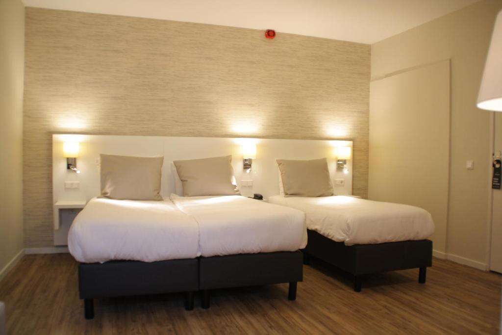 Postel nebo postele na pokoji v ubytování Hotel Andante aan Zee