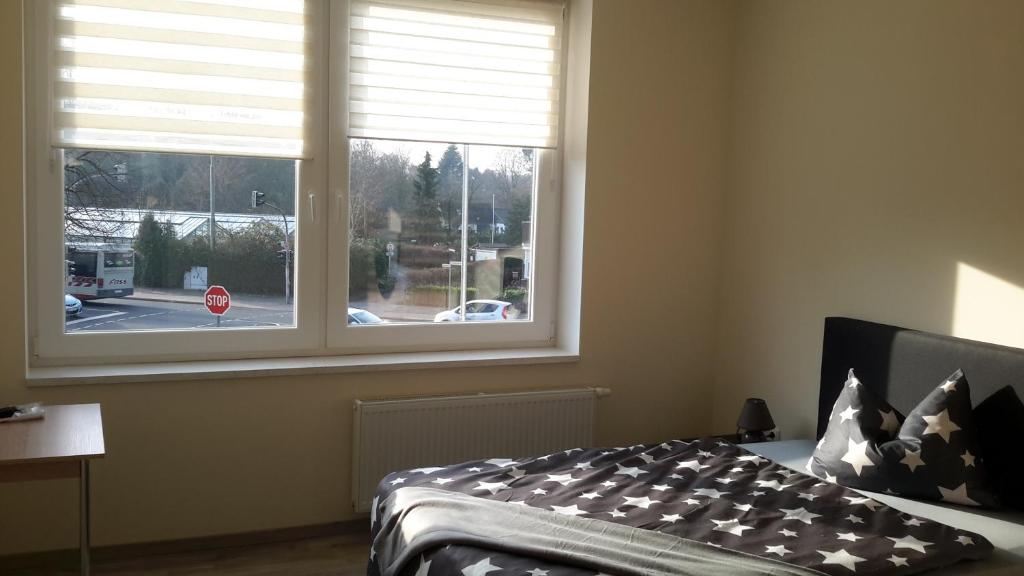 a bedroom with a bed and a window with a stop sign at Workers Sleep in Wilhelmshaven