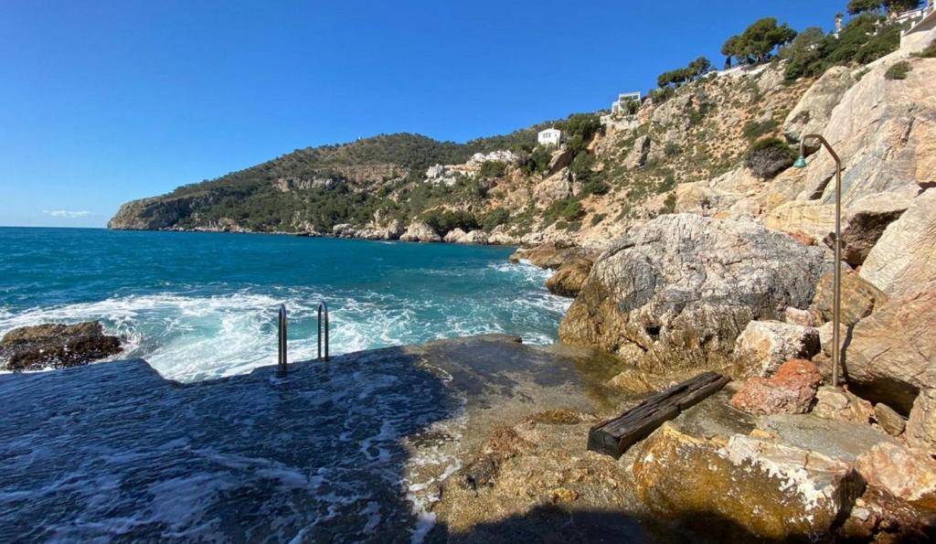 a view of the ocean from a rocky shore at Blue Charme in La Herradura