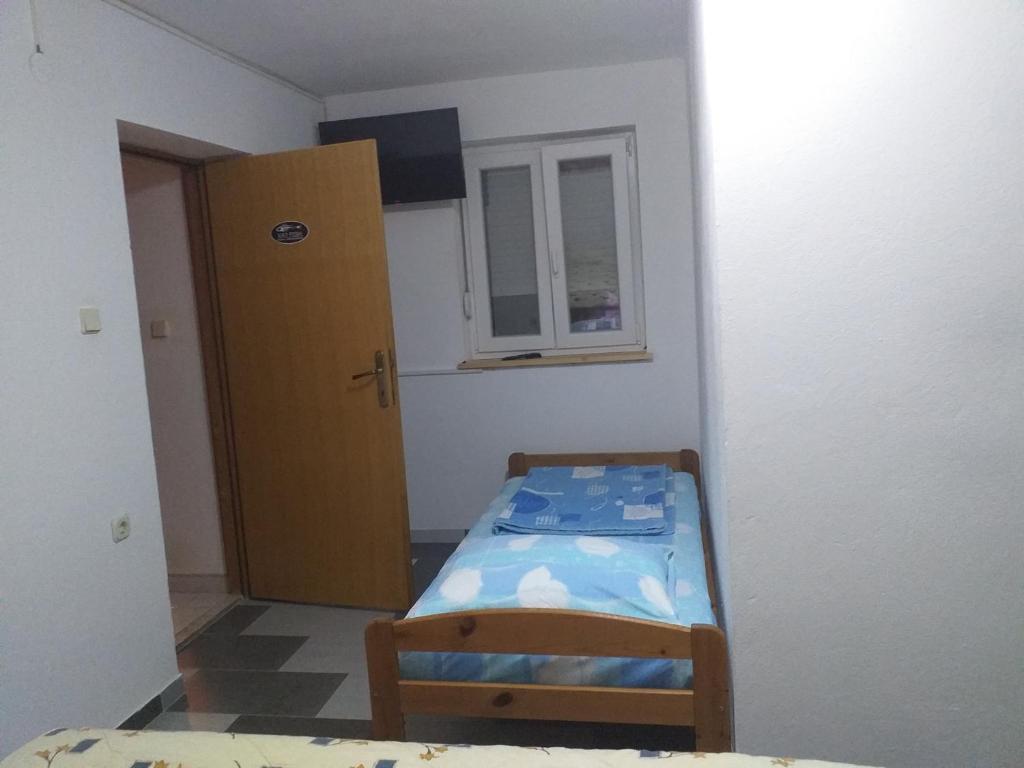 Postel nebo postele na pokoji v ubytování Apartmani Branka