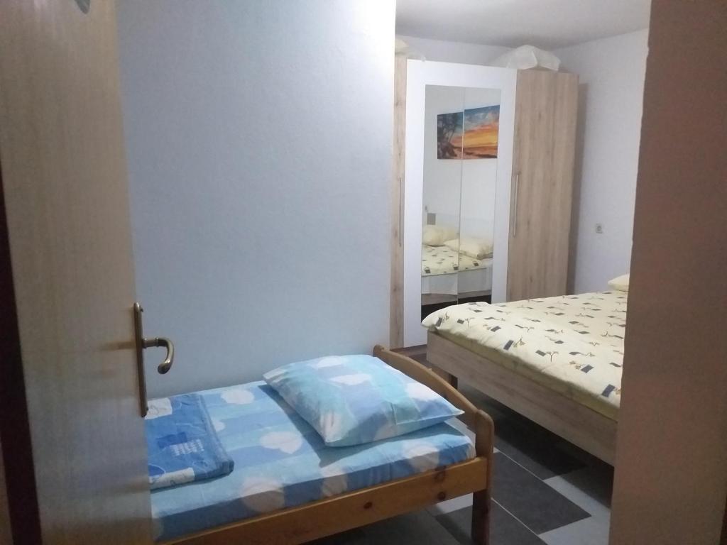 Postel nebo postele na pokoji v ubytování Apartmani Branka