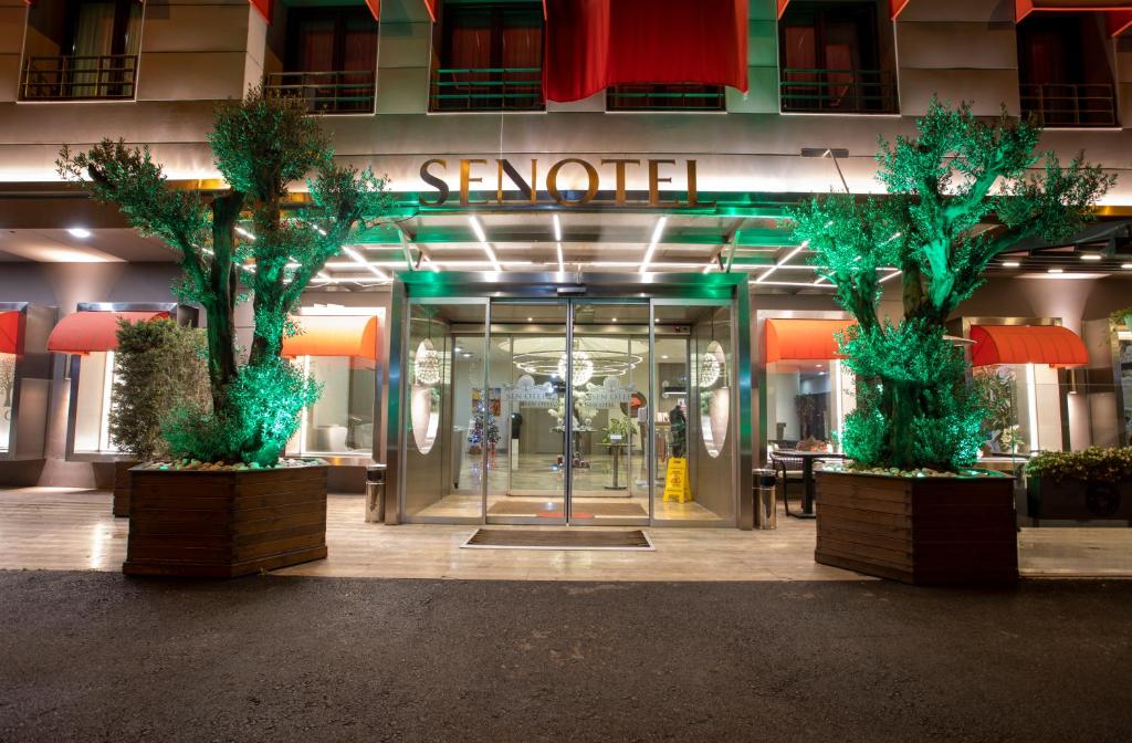 a lobby of a building with two trees in front of it at Sen Otel in Sakarya