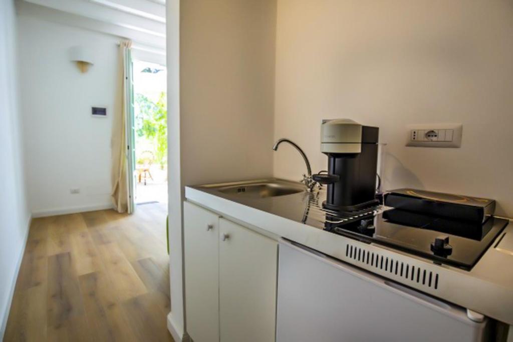 a kitchen with a sink and a stove top oven at Maison d'Orange - La Pinede in Saint-Tropez