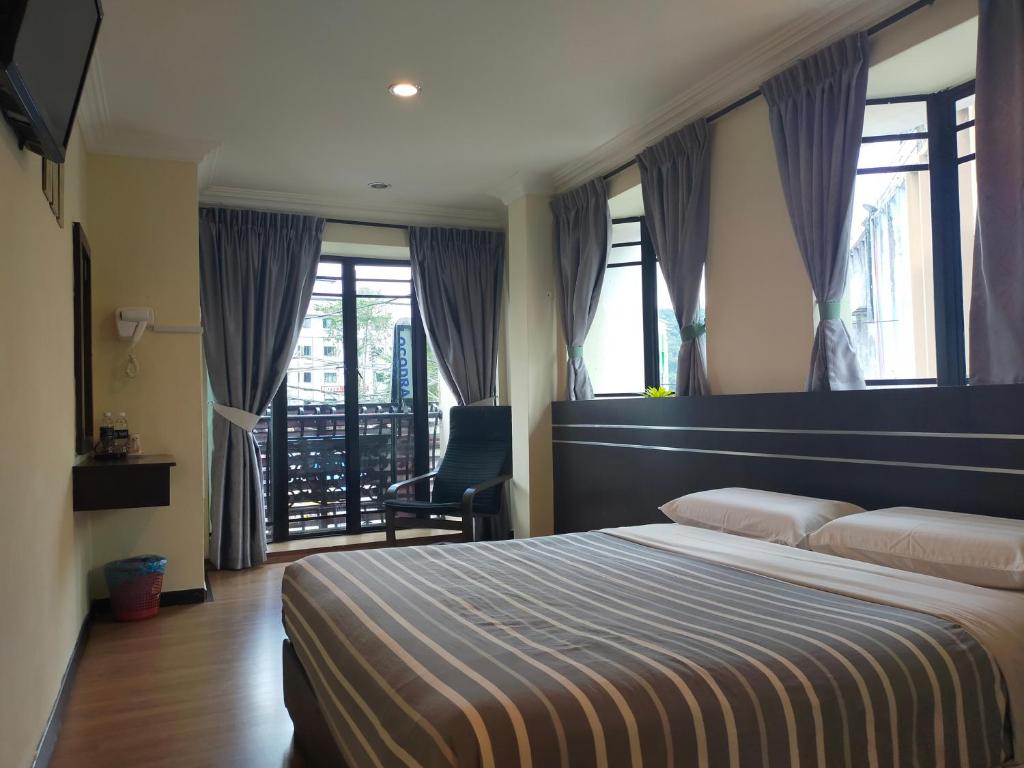 Postel nebo postele na pokoji v ubytování Hong Kong Hotel