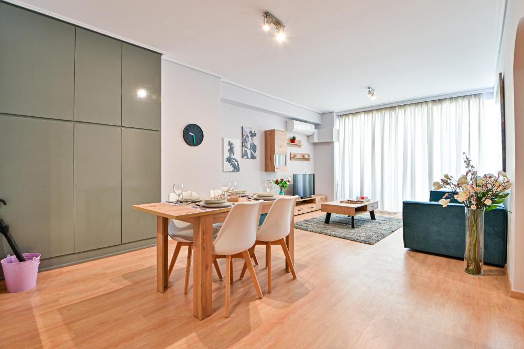 a kitchen and dining room with a table and chairs at Modern flat in the heart of Port of Piraeus (D2) in Piraeus