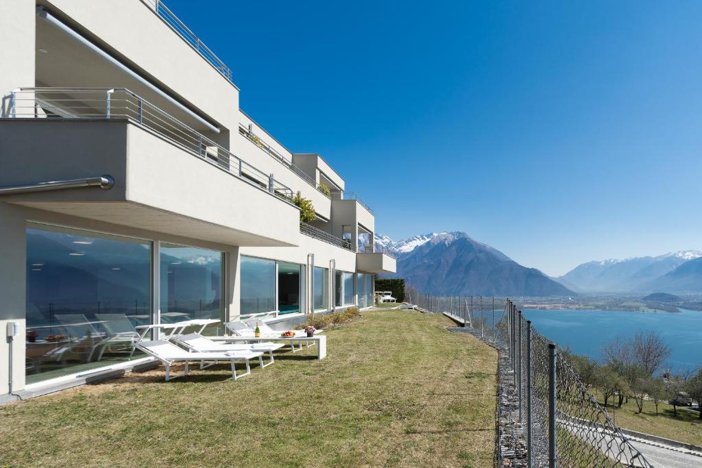 a house on the hill with a view of the water at Valarin Luxury Apartments & Wellness, Vercana by Rent All Como in Vercana