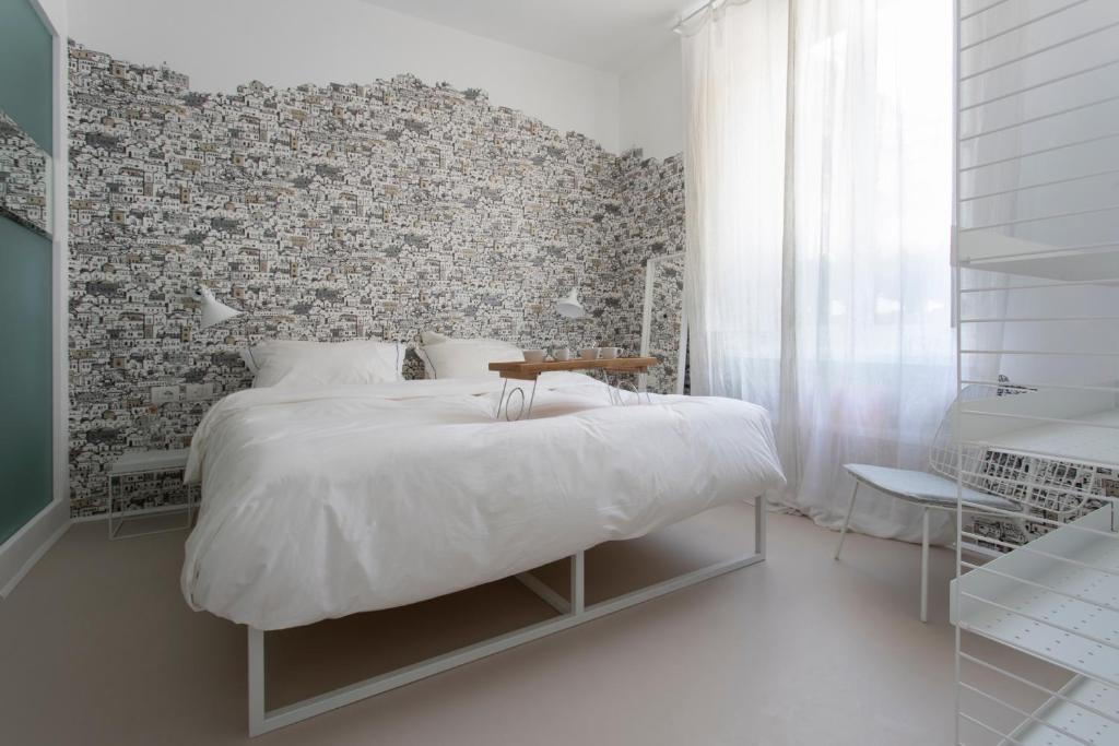 A bed or beds in a room at Piazza Fanti Luxury Apartments