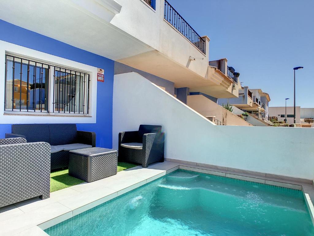 a swimming pool with chairs and a couch in a building at Casa Croft - 4609 in San Javier
