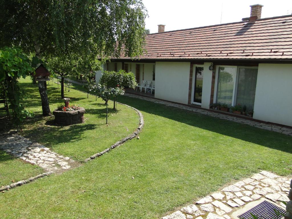 a house with a yard with a lawn sidx sidx sidx sidx at Lázár Apartman in Balatonlelle