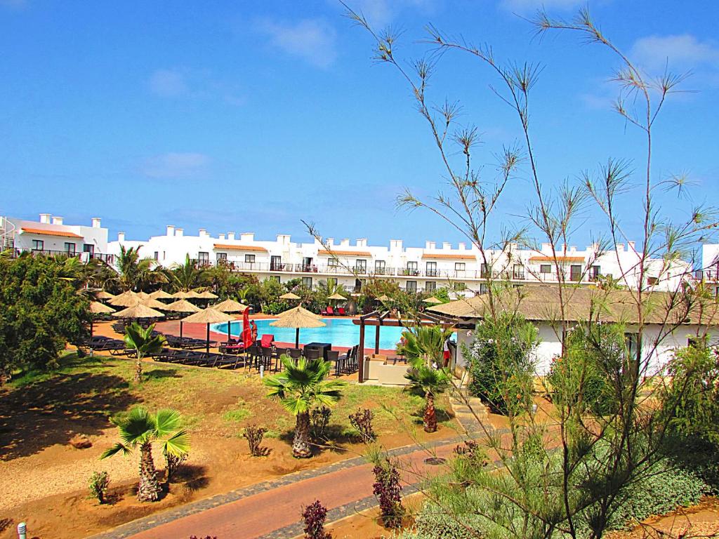 a resort with a pool and tables and umbrellas at BCV - Private Apartments Dunas Resort 1 & 2 Beds in Santa Maria