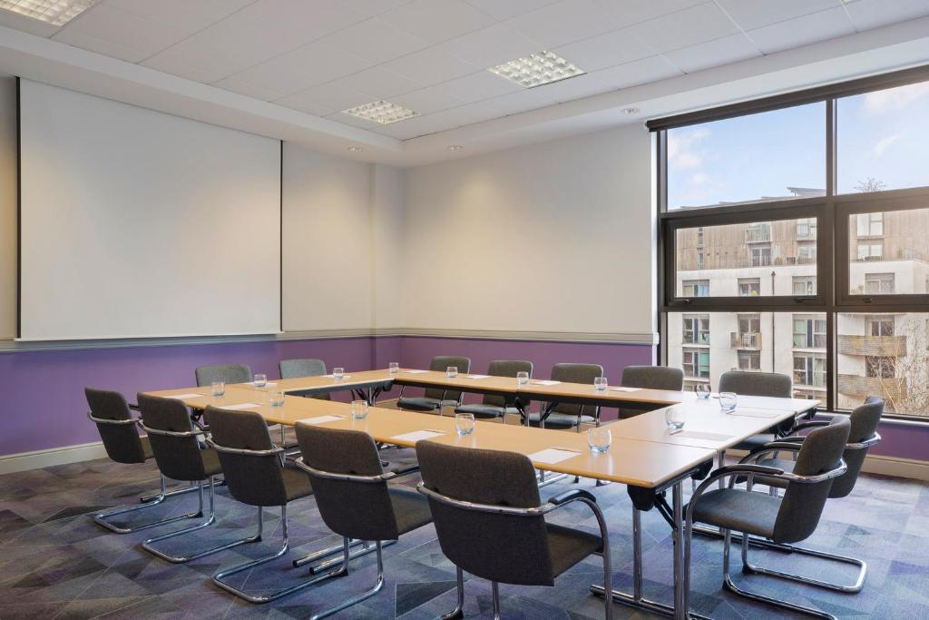 a conference room with a large table and chairs at Leonardo Hotel Brighton in Brighton & Hove