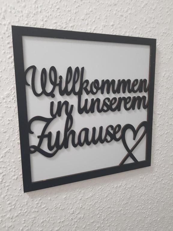 a picture of a sign on a wall with a heart at Großzügige Fewo in Wittenberge -DaLaRi in Wittenberge