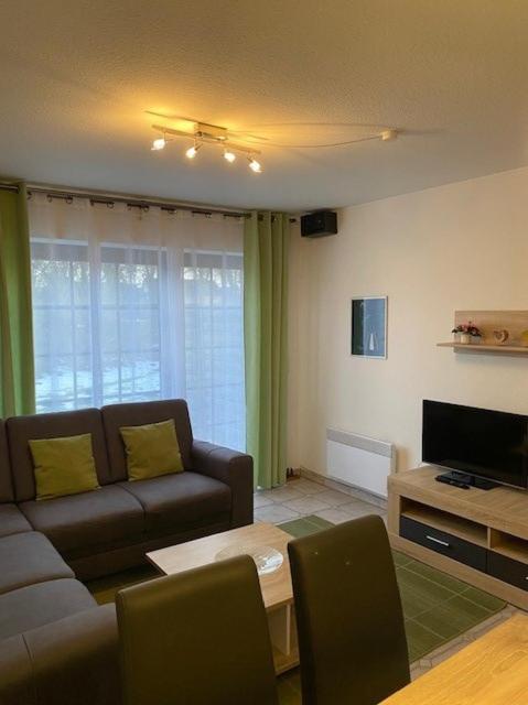 a living room with a couch and a television at Saarstrasse 18h in Dahme