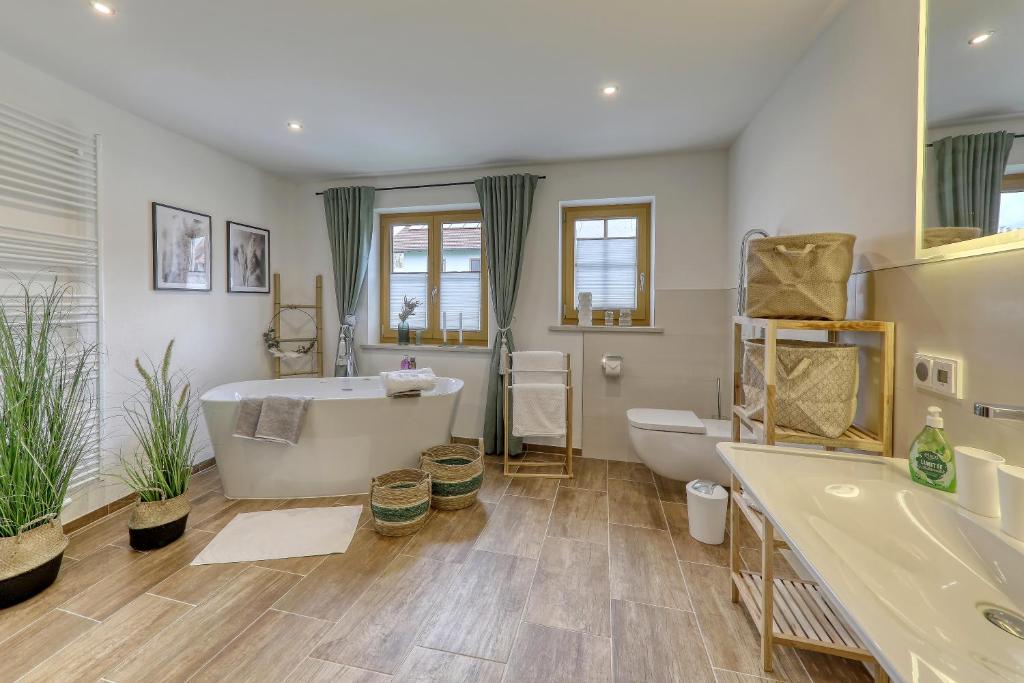 a bathroom with a tub and a toilet and a sink at Ferienwohnungen Madek in Mauth