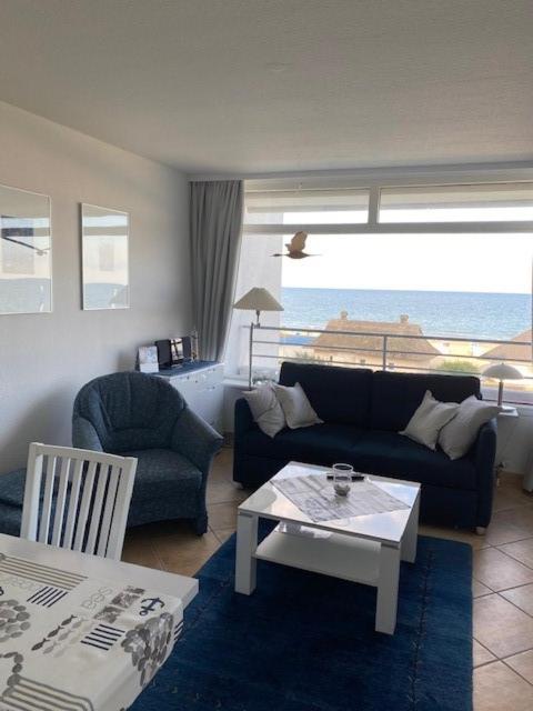 a living room with a couch and a table at Strandhotel Wohnung 28 in Dahme