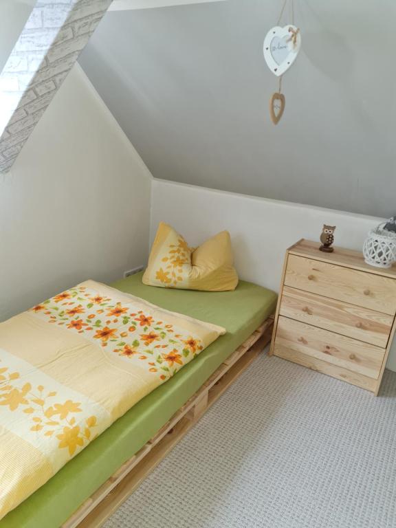 a bedroom with two beds and a wooden cabinet at Haus Steindöbra in Klingenthal