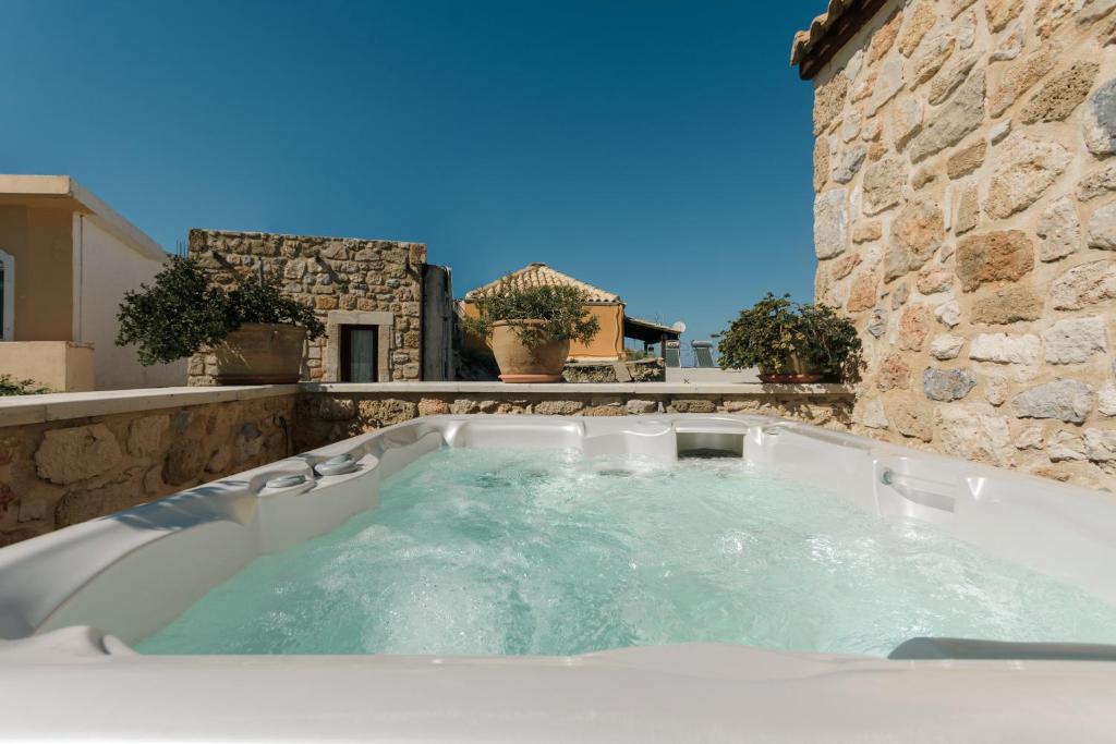 a jacuzzi tub in a stone building at Casa Di Veneto in Hersonissos