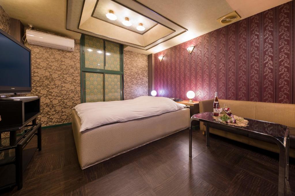 Postel nebo postele na pokoji v ubytování Hotel ニャンだふる