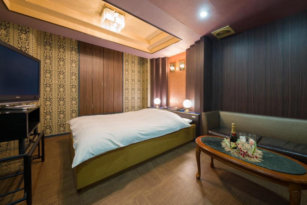 Postel nebo postele na pokoji v ubytování Hotel ニャンだふる