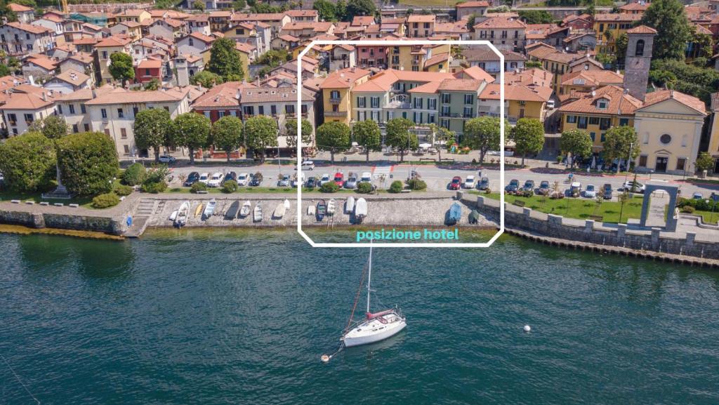 a boat in a body of water with aoit at Albergo Pesce D'oro in Verbania