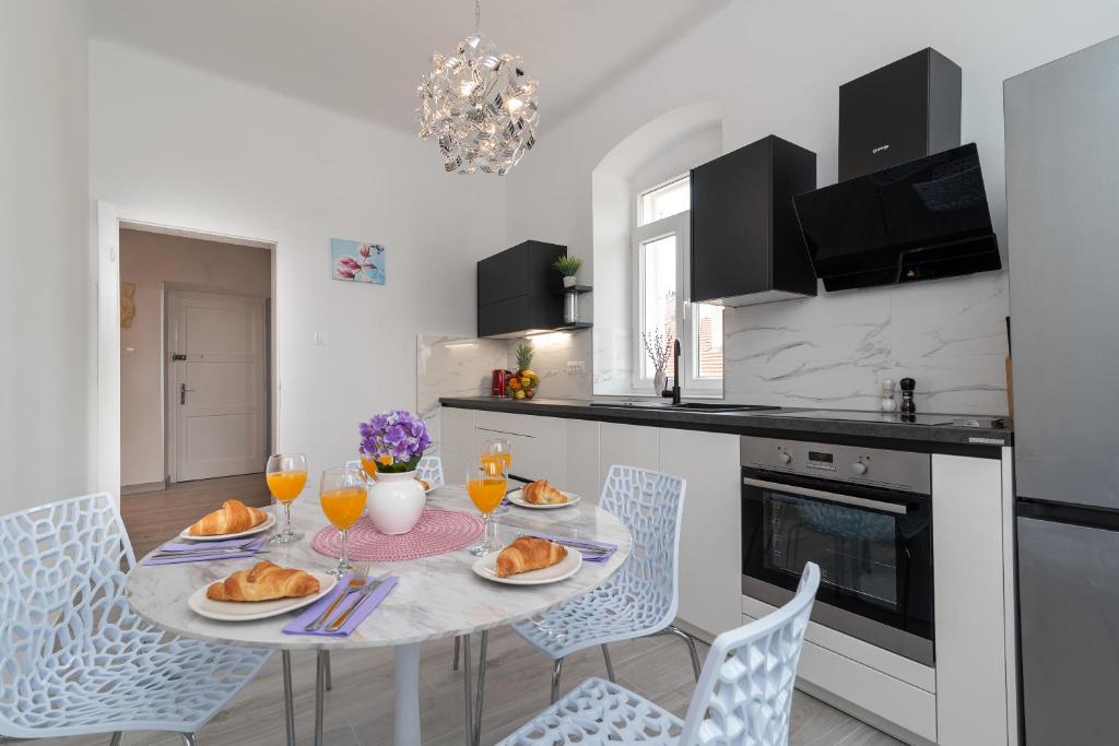 a kitchen with a table with plates of food on it at Apartment Silvia in Trogir