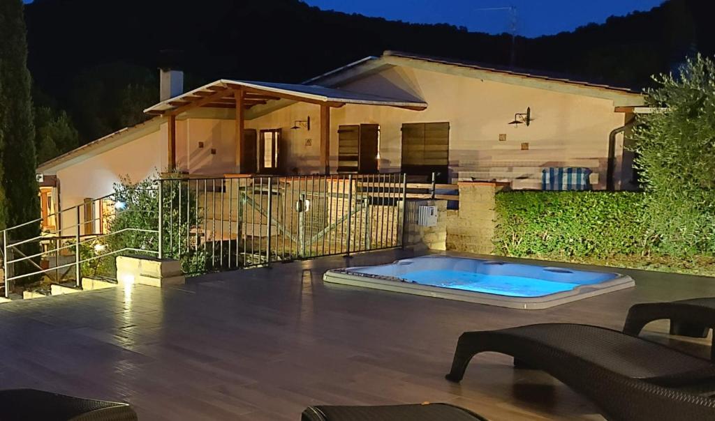 a house with a swimming pool in front of a house at Locanda Mossa Dei Barbari in Buriano