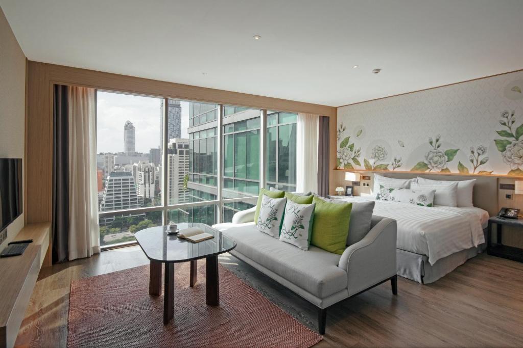 Postel nebo postele na pokoji v ubytování Sivatel Bangkok Hotel