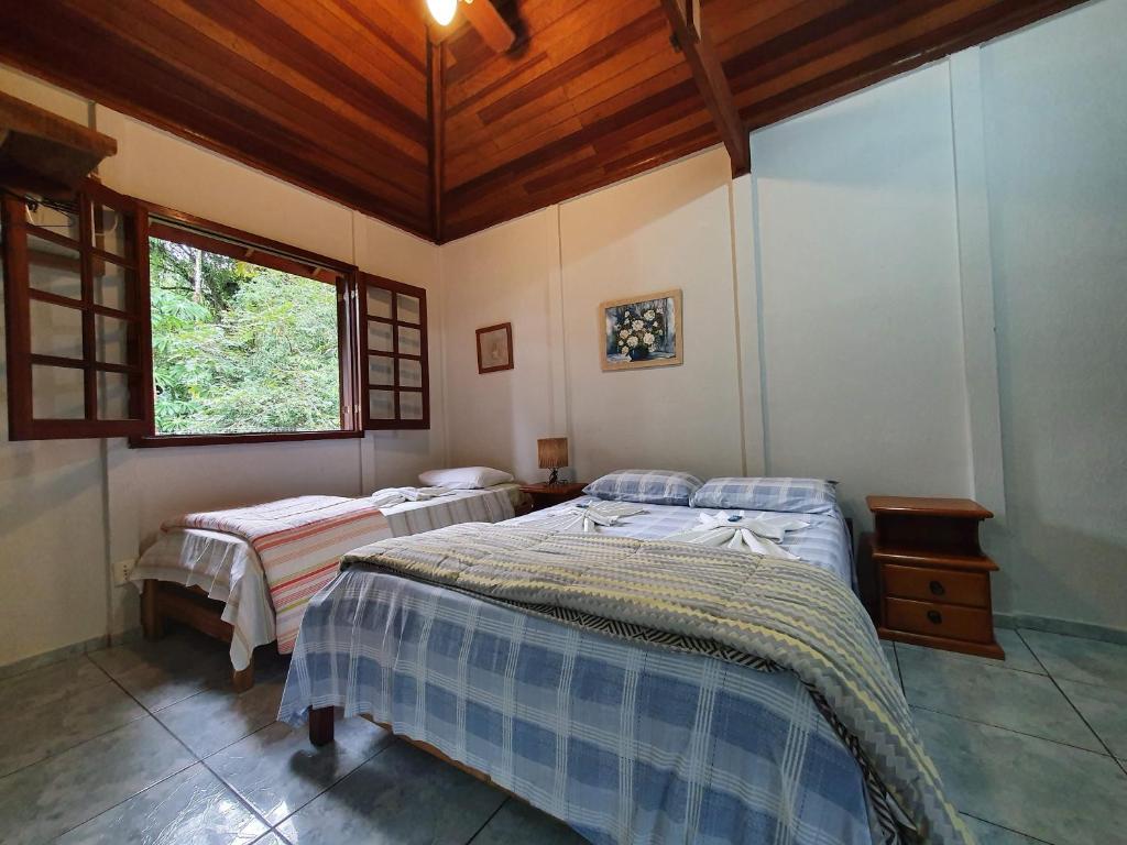 Postel nebo postele na pokoji v ubytování Pousada Canto do Curió Paraty